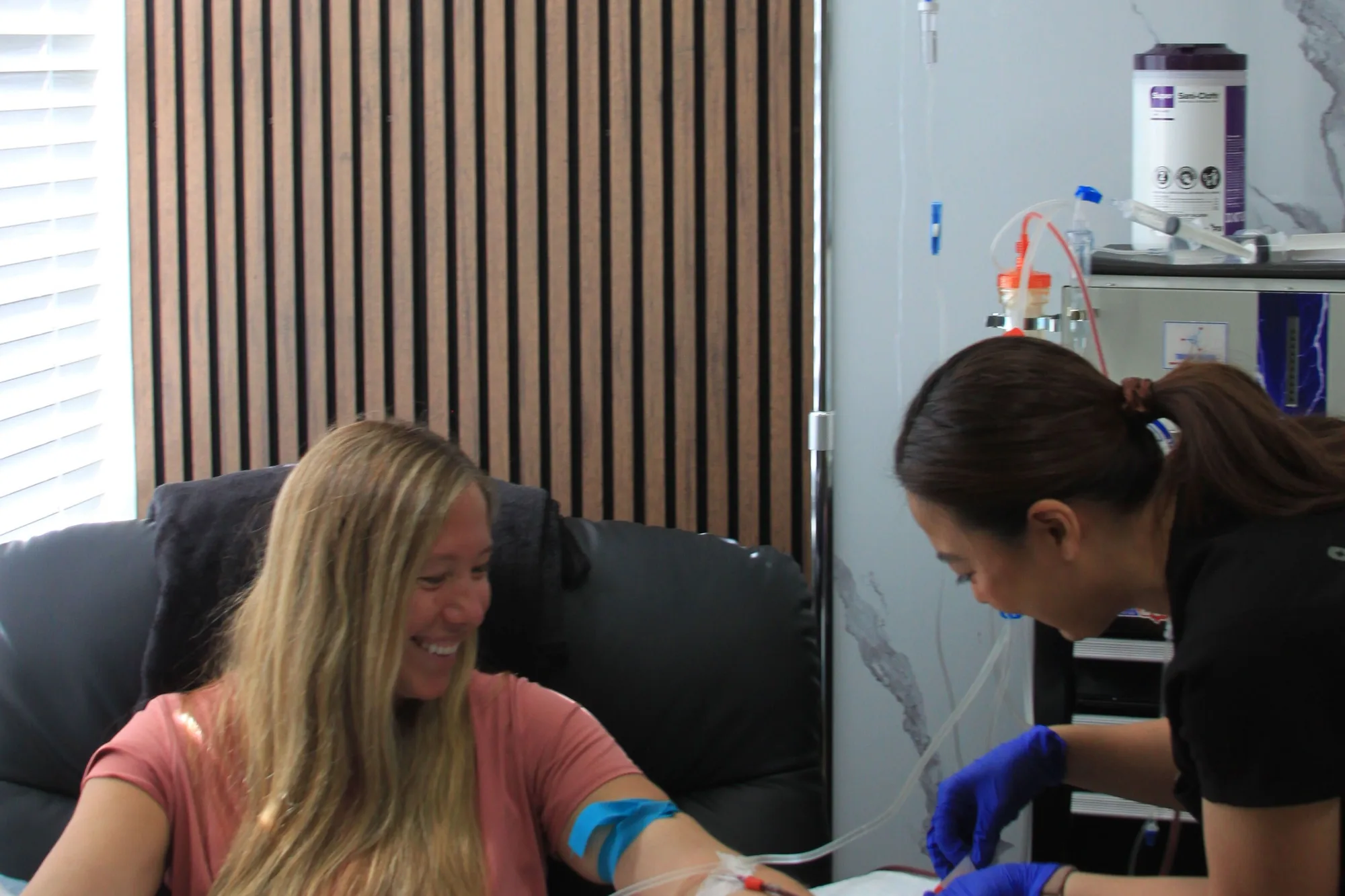 A clinician at SeaCoast Clinic drawing blood from a patient in the treatment chair